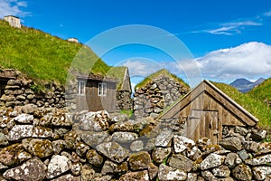 View of fishing village in Koltur island. Faroe Islands. Green roof houses. Nordic natural landscape