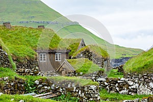 View of fishing village in Koltur island. Faroe Islands. Green roof houses. Nordic natural landscape