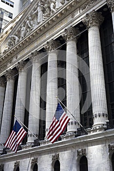 Flags wave outside the New York Stock Exchange, New York, USA