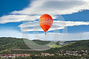 Orange balloon amid blue sky . soar in the clouds photo