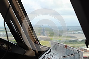 View from a flight deck window on a runway, just before landing