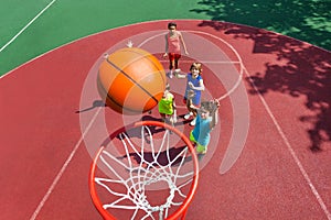 View of flying ball to basket from top, teens play