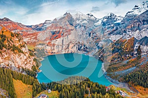 View from flying drone. Attractive autumn view of unique Oeschinensee Lake. Captivating morning scene of Swiss Alps with Bluemlisa