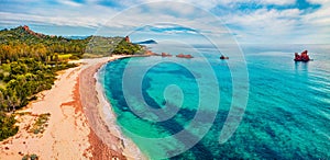 View from flying drone. Captivating summer view of di Cea beach with Red Rocks Gli Scogli Rossi - Faraglioni. Aerial morning scene photo