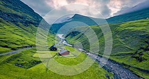 View from flying drone. Gorgeous summer view of Saksun village. Majestic morning scene of Pollurin canyon, Faroe Islands, Kingdom