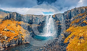 View from flying drone of Gufufoss Gufu Waterfall. Gloomy midnight sun scene of typical volcanic landscape of Iceland, Europe. B