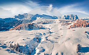 View from flying drone of Italian ski resort. Beautiful morning view of Dolomite Alps.