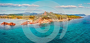 View from flying drone. Panoramic summer view of di Cea beach with Red Rocks Gli Scogli Rossi - Faraglioni. Aerial morning scene o photo