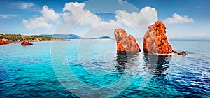 View from flying drone. Panoramic summer view of Red Rocks Gli Scogli Rossi - Faraglioni on the di Cea beach. Impressive morning s photo