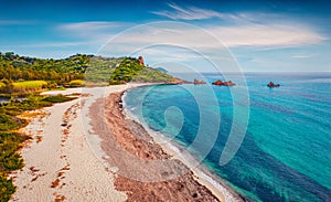 View from flying drone. Perfect summer view of di Cea beach with Red Rocks Gli Scogli Rossi - Faraglioni. Picturesque morning scen photo