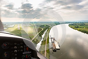 View from a flying sport plane over river landscape