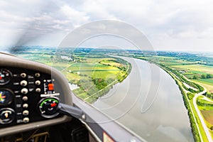 View from a flying sport plane over river landscape