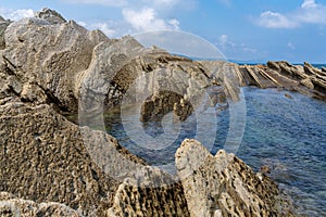 View of the Flysch rock formations and tidal pools on the Basque Country coast near Zumaia