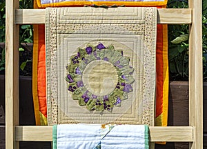 View of folded star Quilts On Wooden Stand