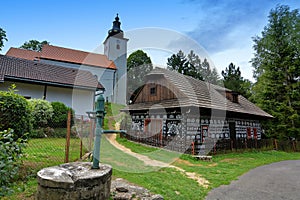 Church and traditional wooden house Cicmany, Slovakia