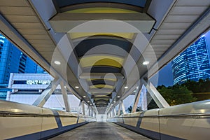 View of footbridge at night in Hong Kong