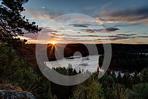 View of forest and lake at sunrise