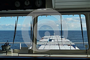 View form the window  of the navigational bridge of the container vessel on the containers covered with snow underway.