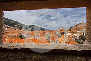 View through the fort window to the roof top of Old town in Dubrovnik, Dalmatia, Croatia