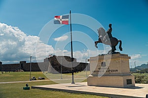 View of the fortress Fortaleza San Felipe and General Gregorio Luperon statue in Puerto Plata photo