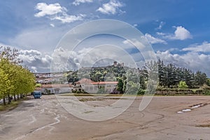 View of the fortress and Luso Roman castle of Ã“bidos, with buildings of Portuguese vernacular architecture and sky with clouds,