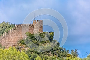 View of the fortress and Luso Roman castle of Ã“bidos, with buildings of Portuguese vernacular architecture and sky with clouds,