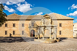 View at the fountain of Santa Maria with st.Philip seminary building in Baeza, Spain photo