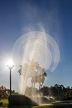 View of the fountain soaring with sunlight above the lanterns