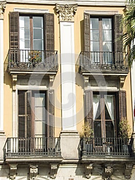 Four windows with balconys on a wall background