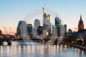 View of Frankfurt am Main skyline at dusk along Main river with