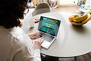 View of freelancer using laptop with