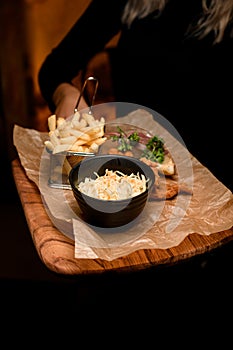 view of french fries and bowl of sauerkraut and delicious batter fried pork ears