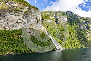 View on Friarfossen waterfall in Geiranger fjord from cruise ship in summer