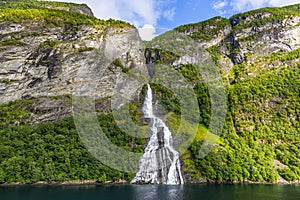 View on Friarfossen waterfall in Geiranger fjord from cruise ship in summer