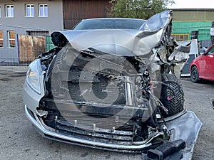 View of the front of a car badly damaged during a car accident. In this condition, the car is immovable and very