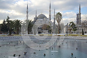 View of the frozen city fountain and the Blue mosque on a winter day. Istanbul