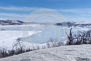 View of the frozen lake SlÃÂ¸ddfjorden near the village of HaugastÃÂ¸l, in the municipality of Hol, Viken County, Norway photo