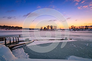 View of a frozen lake during sunrise in winter season.