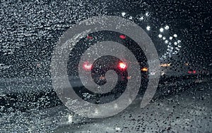 View through frozen windshield on the winter road during snowfall