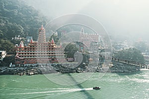 View of Ganga river embankment, Lakshman Jhula bridge and Tera Manzil Temple, Trimbakeshwar in Rishikesh. photo