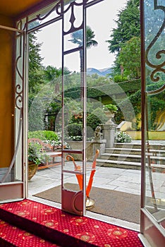 View of the garden through the doors of a hotel in Lake Como