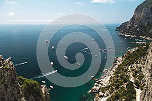 View from the Gardens of Augustus on Capri island coast, sea and boats. Italy