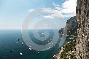 View from the Gardens of Augustus on Capri island coast, sea and boats. Italy