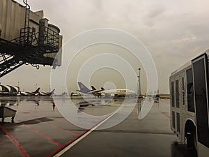 View from the gate while waiting to board an airplane parked in Suvarnabhumi international airport. After rain in the evening of