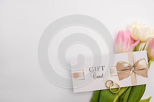 View of gift card, wedding rings