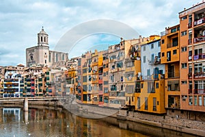 View of Girona Cathedral and multi colored houses from bridge on the Onyar River, Girona