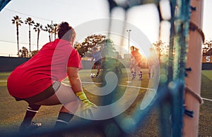 View Through Goal Net Of Womens Football Team Playing Soccer Match