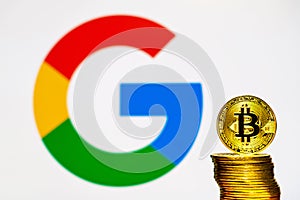 Gold Bitcoin coins with the Google logo on background