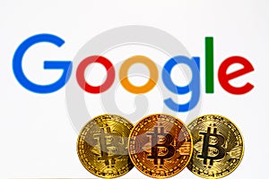 Gold Bitcoin coins with the Google logo on background