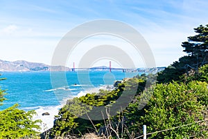 The view of golden gate bridge in Lands end at San Francisco- San Francisco. summer , cloud , rock , sea, plant.